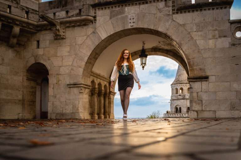 Girl in a corset walking around Buda Castle for a travel photoshoot.