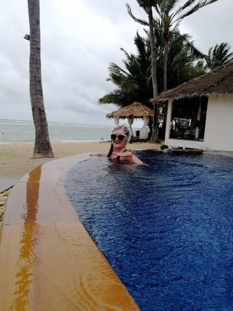 A girl with a shower cap in a pool in thailand after ear surgery in Vietnam - an insane travel story!