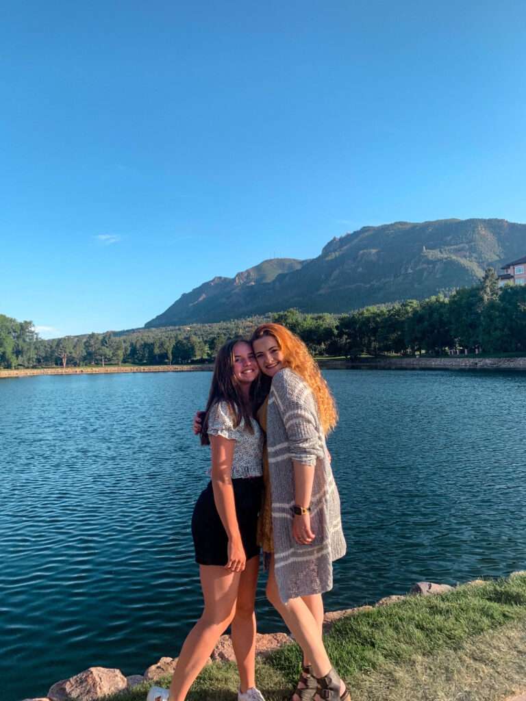 Two cousins posing at the lake at the Broadmoor in Colorado