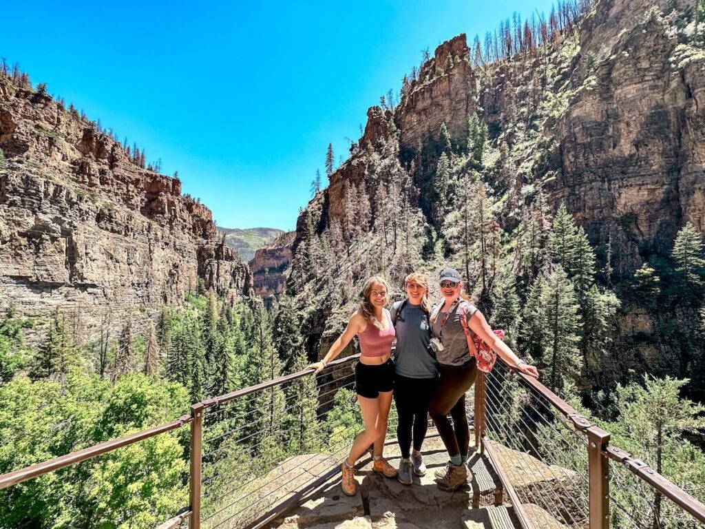 Three friends in front of canyon at hanging lake