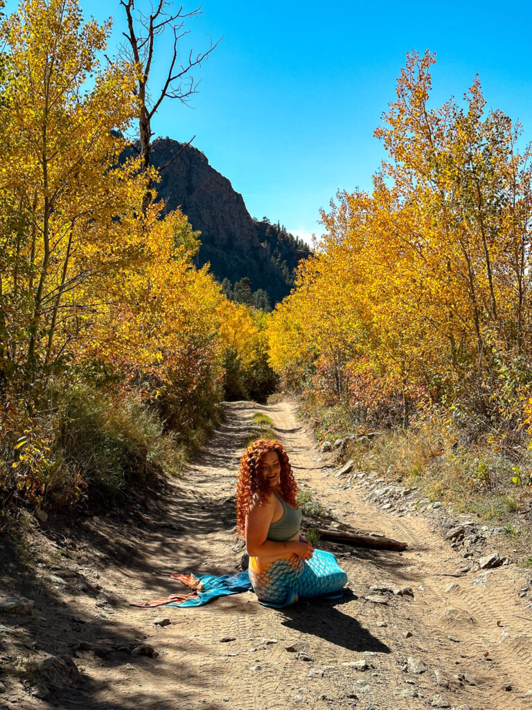 A mermaid sitting in the middle of the road in autumn in Colorado