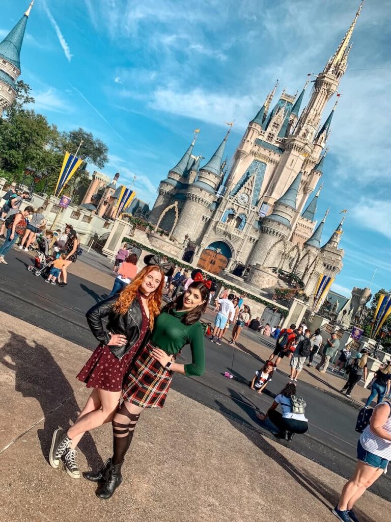 Two friends posing in front of the castle in Disney World, Florida, an idea for a January Bucket list