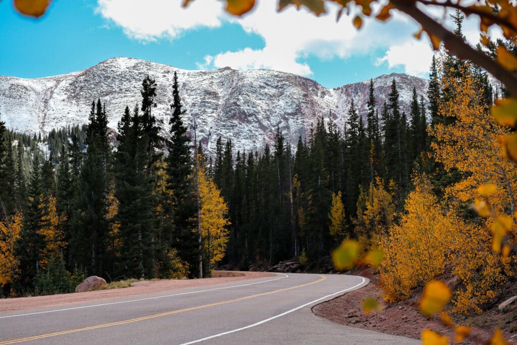 Stunning fall colors with snow-capped mountain in the back on the Pikes Peak Highway