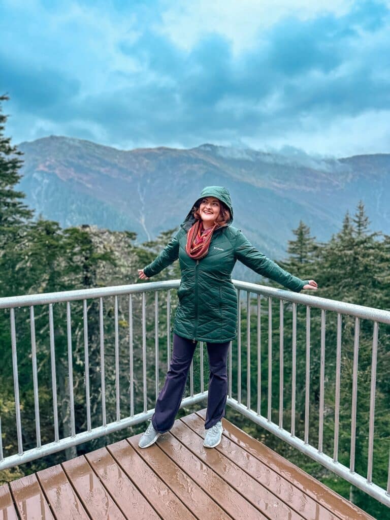 A red haired girl in a green raincoat at the top of the Goldbelt tram in Juneau, Alaska