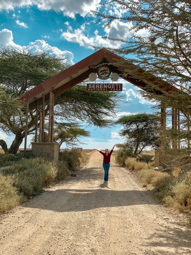 Girl posing in front of Serengeti National Park entrance