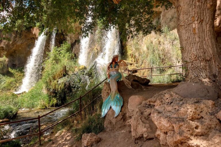 Mermaid sitting on rock at Rifle Falls