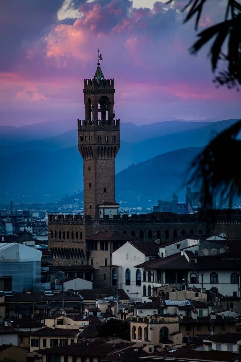 A blue hour photo of the clock tower in Plazza Vecchio from the garden of roses for some Florence Photography