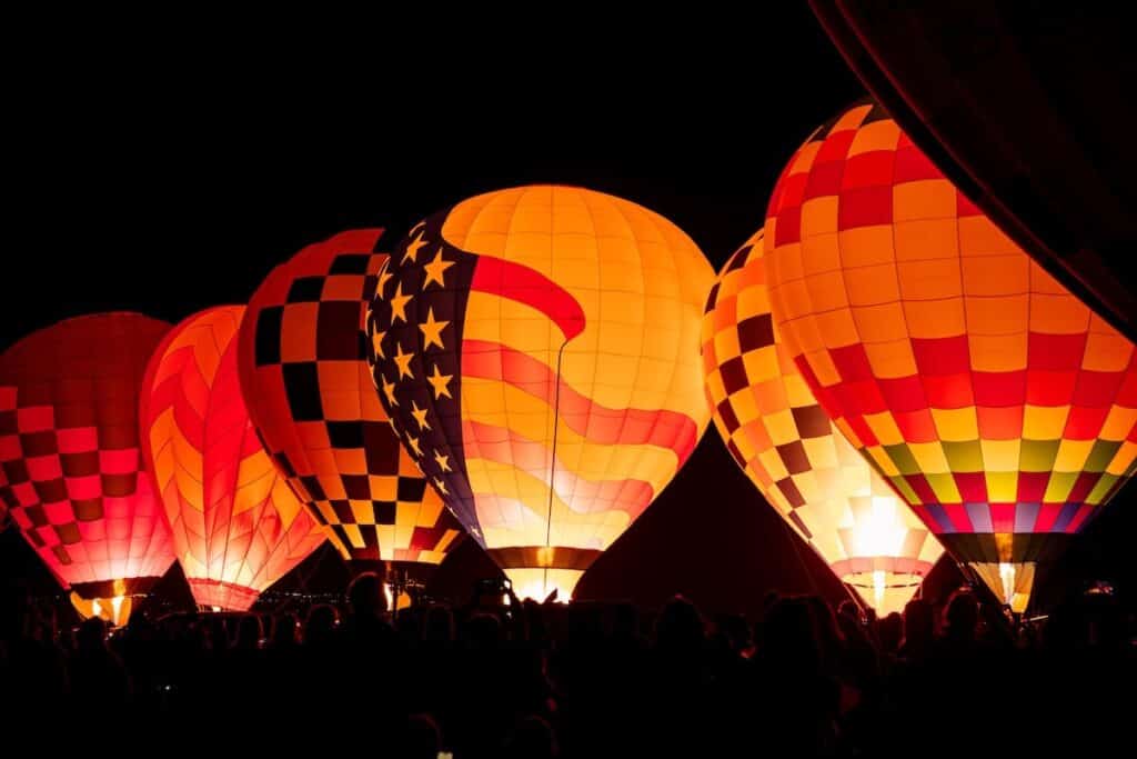 The Dawn Patrol at the 2025 Albuquerque Balloon fiesta; balloons lite up in a row at night.