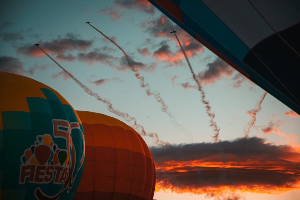 Jets roaring through the sillohoute of 2 balloons in the opening day of the 2025 Albuquerque balloon fiesta