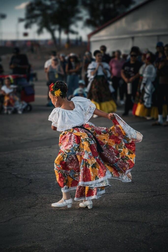 A little girl in a traditional Mexican dress dancing at an event in New Mexico