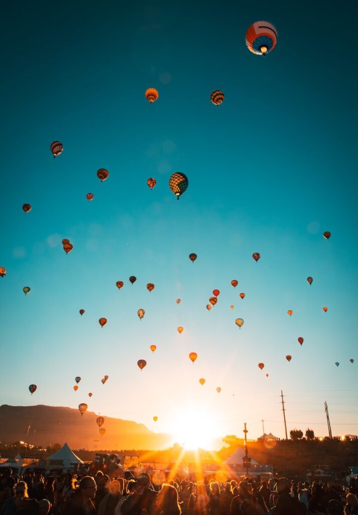 Hundreds of Balloons rising over the sandias at the 2025 Albuquerque Balloon fiesta at sunrise