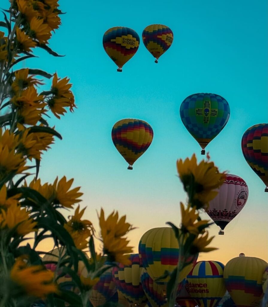 Balloons at sunrise rising over the RV park at the International Balloon Fiesta in Albuquerque.