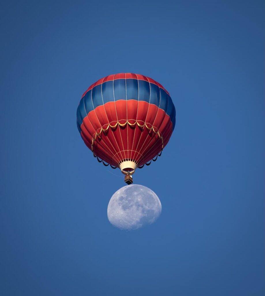 A moon with a balloon on top of it
